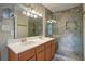 Bathroom featuring tile flooring, double sinks, and a glass enclosed shower at 854 Parkway Se Dr, Smyrna, GA 30080