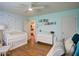 Spacious Bedroom featuring a bed, a crib, hardwood floors, and natural light at 854 Parkway Se Dr, Smyrna, GA 30080