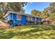 Cozy blue brick home with wood shutters, a flower box, and a well manicured lawn at 854 Parkway Se Dr, Smyrna, GA 30080