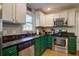 Updated kitchen features sleek black countertops and stainless steel appliances at 854 Parkway Se Dr, Smyrna, GA 30080