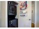 Convenient laundry area with stacked washer and dryer, plus shelving for storage at 854 Parkway Se Dr, Smyrna, GA 30080
