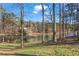 A picturesque backyard with a gentle slope leads to a peaceful lake, perfect for enjoying nature at 1126 Wedgefield Sw Dr, Marietta, GA 30064