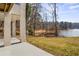 Lush green backyard with a view of the lake visible from under the deck at 1126 Wedgefield Sw Dr, Marietta, GA 30064
