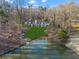 Expansive backyard with lush lawn gently sloping to the tranquil lake, perfect for outdoor activities at 1126 Wedgefield Sw Dr, Marietta, GA 30064