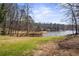 A serene backyard leads to a tranquil lake, offering endless opportunities for outdoor enjoyment and relaxation at 1126 Wedgefield Sw Dr, Marietta, GA 30064