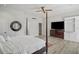 Spacious main bedroom featuring a four-poster bed, hardwood floors, ceiling fan, and built-in storage at 1126 Wedgefield Sw Dr, Marietta, GA 30064
