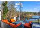 Relax on the expansive deck with ample seating and beautiful waterfront views, ideal for outdoor living at 1126 Wedgefield Sw Dr, Marietta, GA 30064