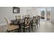 Well-lit dining room with wood table and seating for eight, plus outdoor access and wood-look flooring at 1126 Wedgefield Sw Dr, Marietta, GA 30064