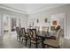 Well-lit dining room featuring a large wood table, seating for eight, and access to an outdoor space at 1126 Wedgefield Sw Dr, Marietta, GA 30064