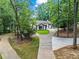 Charming home featuring a well-manicured lawn, a circular driveway, and lush greenery at 1126 Wedgefield Sw Dr, Marietta, GA 30064
