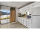 Well-lit kitchen offers ample counter space and a view of the outdoors from the sliding glass door at 1126 Wedgefield Sw Dr, Marietta, GA 30064