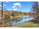 Serene lake view surrounded by lush trees, creating a peaceful and picturesque setting for relaxation and recreation at 1126 Wedgefield Sw Dr, Marietta, GA 30064