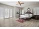 Airy main bedroom featuring a four-poster bed, shuttered windows, and wood-look floors at 1126 Wedgefield Sw Dr, Marietta, GA 30064