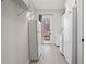 Bright mud room features white walls, wood floors, wire shelving and access to the outdoors at 1126 Wedgefield Sw Dr, Marietta, GA 30064