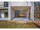 Covered patio on the lower level with a neutral color scheme and access to the backyard at 1126 Wedgefield Sw Dr, Marietta, GA 30064