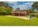 This home's exterior features a spacious yard, multi-level deck, grey garage door, and cozy patio furniture at 2191 Fairfield Se St, Smyrna, GA 30080