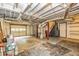 Large basement with exposed ductwork, unfinished flooring, and garage door at 2191 Fairfield Se St, Smyrna, GA 30080