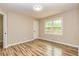 Neutral bedroom featuring wood floors, natural light, and an adjacent doorway at 2191 Fairfield Se St, Smyrna, GA 30080