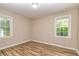 Bedroom featuring vinyl plank flooring, natural lighting, and neutral paint at 2191 Fairfield Se St, Smyrna, GA 30080