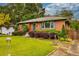 Front yard with shrubbery and grass alongside a brick home with inviting entry at 2191 Fairfield Se St, Smyrna, GA 30080