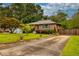 Brick home with driveway featuring landscaped yard and mature trees at 2191 Fairfield Se St, Smyrna, GA 30080