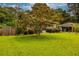 Well-maintained front lawn with mature tree accenting the brick home's exterior at 2191 Fairfield Se St, Smyrna, GA 30080