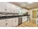 Bright kitchen with white cabinets, granite countertops, and stainless steel appliances at 2191 Fairfield Se St, Smyrna, GA 30080