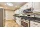 Modern kitchen with stainless steel appliances, granite counters, and tile backsplash at 2191 Fairfield Se St, Smyrna, GA 30080