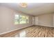 Bright living room featuring wood floors, a modern light fixture, and large window at 2191 Fairfield Se St, Smyrna, GA 30080