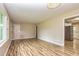 Open living room with wood floors, neutral walls, and seamless flow to kitchen at 2191 Fairfield Se St, Smyrna, GA 30080