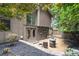 Inviting backyard featuring a cozy fire pit area with seating, complemented by mature trees and charming home at 225 Lakeview W Rdg, Roswell, GA 30076