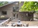 Cozy backyard patio with fire pit and seating, complemented by a charming two-story home at 225 Lakeview W Rdg, Roswell, GA 30076