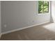 Cozy bedroom with neutral walls, carpet flooring, and a window at 225 Lakeview W Rdg, Roswell, GA 30076