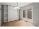 Bright bedroom with built-in shelves, light fixture, wood floors, and french doors to a patio at 225 Lakeview W Rdg, Roswell, GA 30076