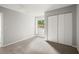 Bright bedroom with neutral walls, plush carpet, closet and a view from the window at 225 Lakeview W Rdg, Roswell, GA 30076