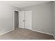 Bedroom featuring light-colored walls, carpet, and a closet with sliding doors at 225 Lakeview W Rdg, Roswell, GA 30076