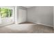 Carpeted bedroom with closet and a large window allowing natural light at 225 Lakeview W Rdg, Roswell, GA 30076
