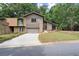 Charming two-story home with a well-maintained lawn, garage, and inviting front entrance at 225 Lakeview W Rdg, Roswell, GA 30076