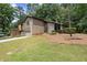 Home with a well-kept lawn, lush landscaping, driveway, and a two-car garage at 225 Lakeview W Rdg, Roswell, GA 30076