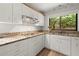 Bright kitchen with stainless steel appliances, granite countertops, and a window view of the lush outdoors at 225 Lakeview W Rdg, Roswell, GA 30076