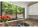 Bright kitchen with granite countertops and a window view of the lush outdoors with a picket fence at 225 Lakeview W Rdg, Roswell, GA 30076
