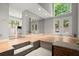 Open living room with mirrored wall, step-down living room, and French doors at 225 Lakeview W Rdg, Roswell, GA 30076