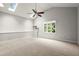 Large, carpeted living room features a skylight, ceiling fan, and a large window at 225 Lakeview W Rdg, Roswell, GA 30076
