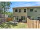 View of the backyard with privacy fence and rear exterior of home at 3473 Shoal Oak Ct, Riverdale, GA 30296