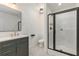 Modern bathroom featuring a sleek vanity with gold hardware, a black-framed shower, and neutral wall colors at 3473 Shoal Oak Ct, Riverdale, GA 30296