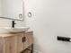 Bathroom features a modern sink with wooden vanity and black hardware at 3473 Shoal Oak Ct, Riverdale, GA 30296