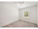 Bright bedroom featuring neutral carpet, a window with blinds, a ceiling fan and freshly painted walls at 3473 Shoal Oak Ct, Riverdale, GA 30296