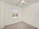 Bright bedroom featuring neutral carpet, a window with blinds, and freshly painted walls at 3473 Shoal Oak Ct, Riverdale, GA 30296