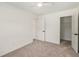 Bright bedroom with neutral carpet and freshly painted walls with open door to walk in closet at 3473 Shoal Oak Ct, Riverdale, GA 30296