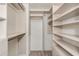 Walk-in closet with wood shelves and gold hardware at 3473 Shoal Oak Ct, Riverdale, GA 30296